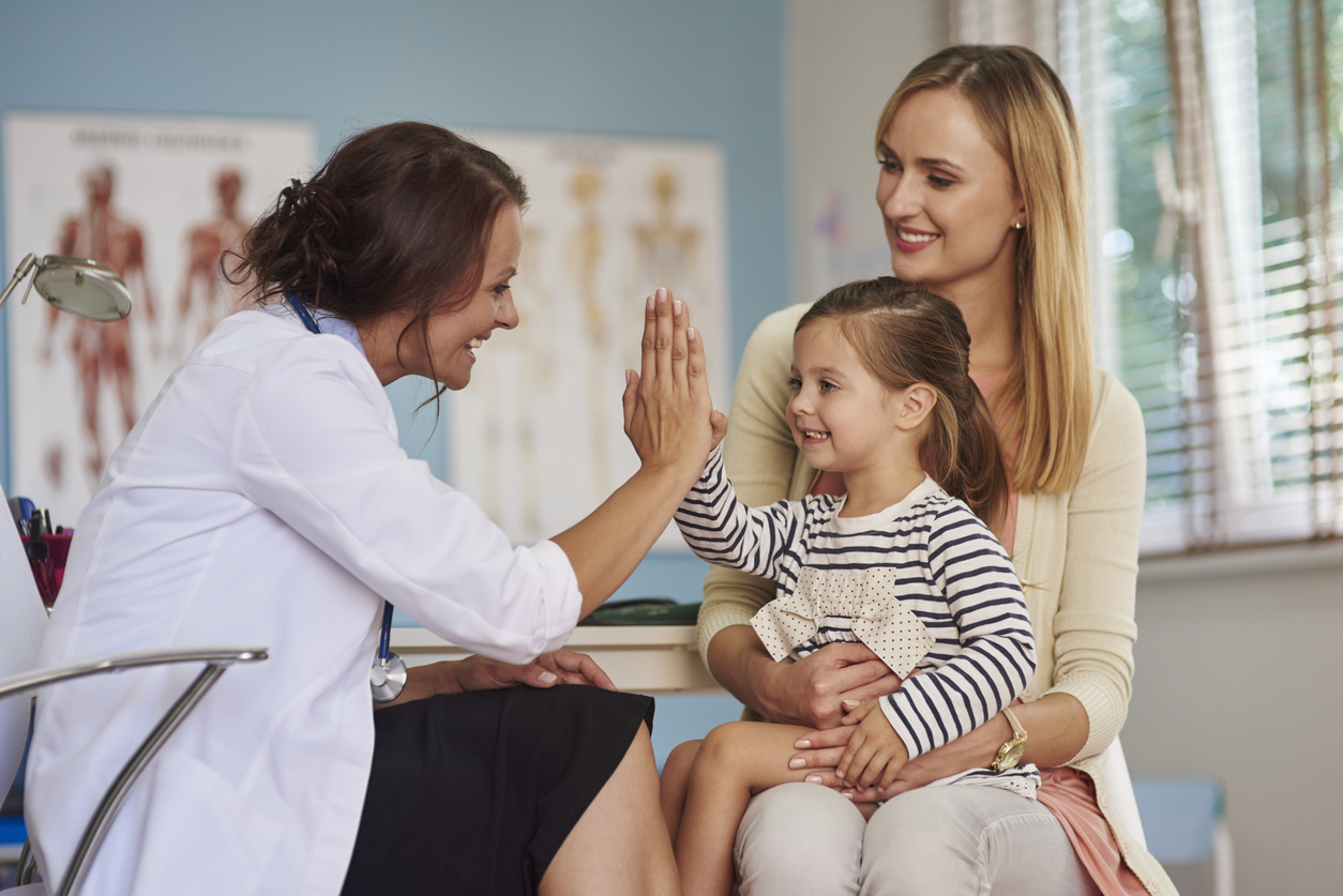 Women's Child giving hi-five to her family doctor
