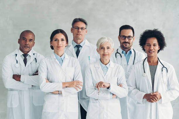 Multiracial group of doctors standing together and looking at camera